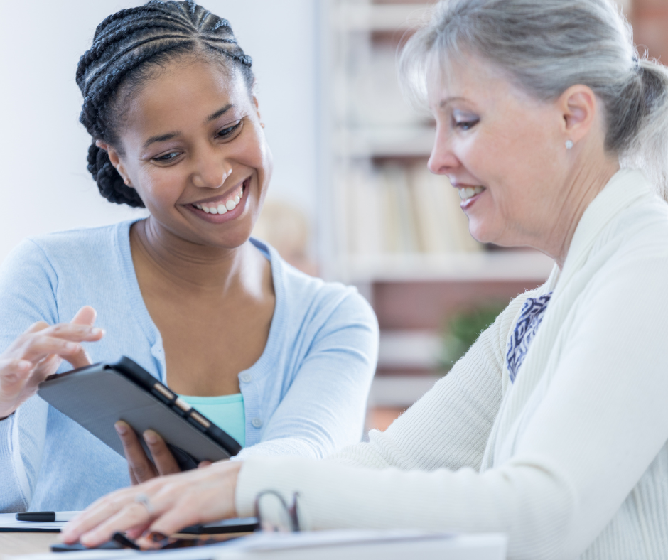 Financial Advisor with older woman client showing her the Whisper Retirement Calculator